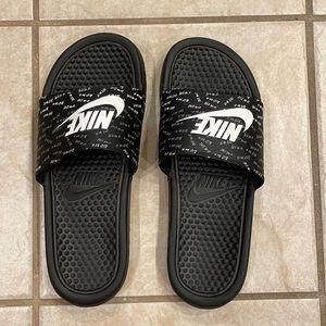 Nike slides in black with white lettering.  Size 9.